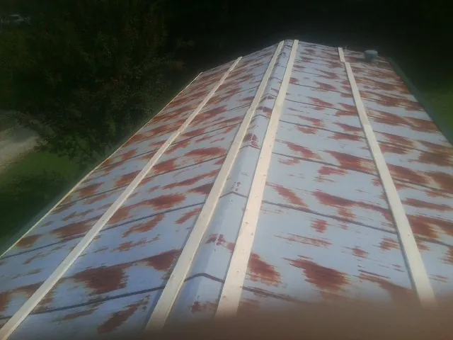 Rusted metal roof panels with new wood purlins before replacement — Storm Damage Roof Repair in Oshkosh by Roofing Brothers