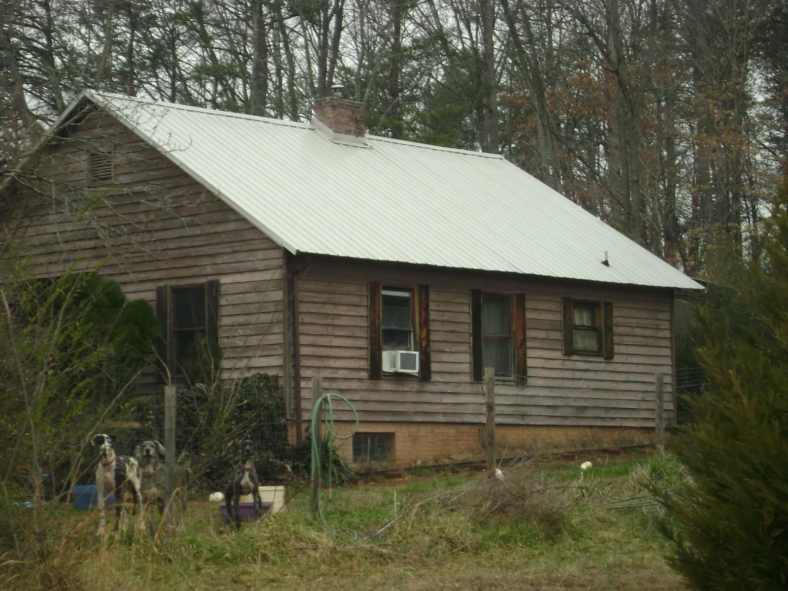 White metal roof on an old wood sided farmhouse, from a Metal Roof Installation job in Oshkosh